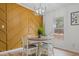Dining room featuring a round table, four chairs, an accent wall, and a window at 92 Papoose Trl, Lillington, NC 27546