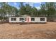 Charming single-story home with a bright red door, black shutters, and a well-maintained front yard at 92 Papoose Trl, Lillington, NC 27546