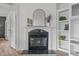 Elegant fireplace with marble surround, decorative mantel, and built-in shelving at 92 Papoose Trl, Lillington, NC 27546