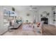 Cozy living room featuring a fireplace, wood floors, and abundant natural light from a large window at 92 Papoose Trl, Lillington, NC 27546