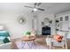 Cozy living room showcasing a fireplace, decorative mirror, ceiling fan, and neutral color palette at 92 Papoose Trl, Lillington, NC 27546