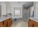 Primary bathroom with double vanity sinks, soaking tub, and separate shower, for a luxurious experience at 101 Cambridge Way, Oxford, NC 27565