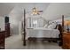Lofted bedroom featuring a four-poster bed, white linens, soft carpet, and ceiling fan at 101 Cambridge Way, Oxford, NC 27565