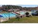 An outdoor swimming pool area with umbrellas and a slide in a Gathering-friendly neighborhood at 101 Cambridge Way, Oxford, NC 27565