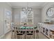 Inviting dining room with stylish chandelier, neutral walls, and a round dining table for six at 101 Cambridge Way, Oxford, NC 27565