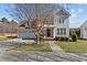 Charming two-story home with well-manicured lawn and two car garage in a suburban neighborhood on a sunny day at 101 Cambridge Way, Oxford, NC 27565