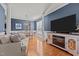 Comfortable living room with wood floors, stylish blue wall, gas fireplace and living space for Gathering and entertaining at 101 Cambridge Way, Oxford, NC 27565