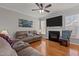 Relaxing living room with fireplace, hardwood floors, a ceiling fan, and lots of natural light at 101 Cambridge Way, Oxford, NC 27565