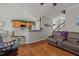 Cozy living space featuring hardwood floors, plush seating, and seamless flow to the kitchen area at 101 Cambridge Way, Oxford, NC 27565