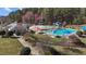 Aerial view of community pool with colorful sunshades, waterslide, and ample lounge space at 101 Cambridge Way, Oxford, NC 27565