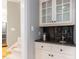 Elegant bar area featuring a countertop sink, glass cabinets, and a granite countertop at 101 Hedwig Ct, Cary, NC 27518