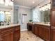 Bathroom featuring a double sink vanity with granite countertop and a glass shower at 101 Hedwig Ct, Cary, NC 27518