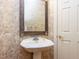 Traditional powder room featuring pedestal sink, decorative wallpaper and a neutral color palette at 101 Hedwig Ct, Cary, NC 27518