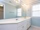 Bathroom with double sink vanity, framed mirror, and window at 101 Hedwig Ct, Cary, NC 27518