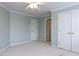 Bedroom with neutral carpet, and trim, plus closet and hallway access at 101 Hedwig Ct, Cary, NC 27518