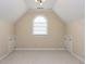 Spacious bedroom with neutral carpet, vaulted ceilings, and window perfect for natural light at 101 Hedwig Ct, Cary, NC 27518