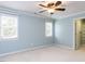 Bright bedroom with carpet, windows, light-blue walls, and closet access at 101 Hedwig Ct, Cary, NC 27518