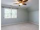 Bedroom featuring carpet flooring, a ceiling fan, and a large window at 101 Hedwig Ct, Cary, NC 27518