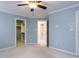 Bedroom with carpet, light-blue walls, walk-in closet, and bathroom access at 101 Hedwig Ct, Cary, NC 27518