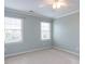 Cozy bedroom features neutral carpet, blue walls, and bright light fixture at 101 Hedwig Ct, Cary, NC 27518