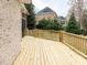Spacious new wooden deck leading to the house with a brick exterior and well-maintained yard at 101 Hedwig Ct, Cary, NC 27518