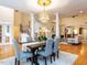 Open-concept dining room with hardwood floors, modern lighting, and seamless flow to living area at 101 Hedwig Ct, Cary, NC 27518