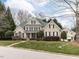 Elegant, two-story brick home boasts a lush lawn and mature landscaping for enhanced curb appeal at 101 Hedwig Ct, Cary, NC 27518
