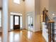 Grand foyer featuring soaring ceilings, hardwood floors, staircase, and ample natural light at 101 Hedwig Ct, Cary, NC 27518