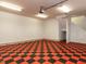 Large garage with checkered flooring, overhead lighting, and ample space for vehicles and storage at 101 Hedwig Ct, Cary, NC 27518