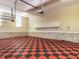 Spacious garage with checkered flooring, overhead lighting, and built-in storage cabinets for organization at 101 Hedwig Ct, Cary, NC 27518