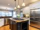 Spacious kitchen featuring a large island, stainless steel appliances, and custom cabinets at 101 Hedwig Ct, Cary, NC 27518