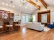 Spacious living room featuring vaulted ceiling, exposed beams, custom bar, and hardwood floors at 101 Hedwig Ct, Cary, NC 27518