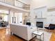 Open-concept living room with fireplace, hardwood floors, and staircase to the second floor at 101 Hedwig Ct, Cary, NC 27518