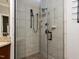 Bathroom shower featuring black fixtures, a shower head, and tiled walls at 101 Hedwig Ct, Cary, NC 27518