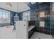 Modern bathroom with a glass-enclosed shower, blue tile, and a freestanding bathtub at 101 Settlecroft Ln, Holly Springs, NC 27540