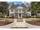 Stunning two-story home with a brick facade, manicured landscaping, and classic architectural details at 101 Settlecroft Ln, Holly Springs, NC 27540