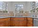 Lovely kitchen with double windows over the sink, granite countertops, and wood cabinets at 101 Settlecroft Ln, Holly Springs, NC 27540