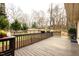 Large deck with wooden flooring and a railing, overlooking the backyard and trees at 103 Westview Dr # D, Carrboro, NC 27510