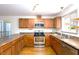 Functional kitchen with stainless steel appliances, wood cabinets, and eat-in space at 103 Westview Dr # D, Carrboro, NC 27510