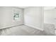 Bedroom featuring a plush carpet, neutral paint, and window views of the neighborhood at 105 Hanover Ct, Clayton, NC 27527