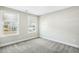 Bedroom with neutral paint, soft carpeting, and large window overlooking the neighborhood at 105 Hanover Ct, Clayton, NC 27527