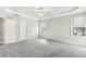 Bright primary bedroom with neutral carpet, two windows, and white trim at 105 Hanover Ct, Clayton, NC 27527