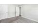 Bedroom with soft carpeting, neutral paint, and an entry to an adjacent room at 105 Hanover Ct, Clayton, NC 27527