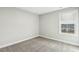 Neutral bedroom with soft carpeting, and a large window offering plenty of natural light at 105 Hanover Ct, Clayton, NC 27527