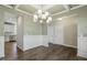 Elegant dining room with coffered ceiling, stylish chandelier, and beautiful hardwood floors at 105 Hanover Ct, Clayton, NC 27527