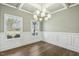 Bright dining room with large windows, coffered ceiling, wainscoting, and hardwood floors at 105 Hanover Ct, Clayton, NC 27527