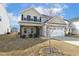 Well-maintained two-story home with a two-car garage, showing the front yard and facade at 105 Hanover Ct, Clayton, NC 27527