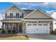 Charming two-story home with stone and siding, featuring a two-car garage and covered front porch at 105 Hanover Ct, Clayton, NC 27527