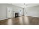 Cozy living room with a fireplace, ceiling fan, hardwood floors, and lots of natural light at 105 Hanover Ct, Clayton, NC 27527