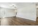Bright living room showcasing hardwood floors, large window, and stairs leading up at 105 Hanover Ct, Clayton, NC 27527